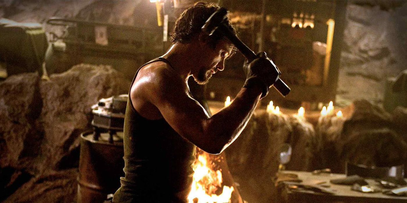 Iron man making his suit in a cave